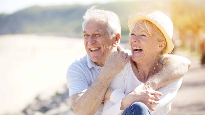 Senior,Couple,Relaxing,By,The,Sea,On,Sunny,Day